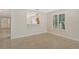 Bright, open-plan living room with tile flooring and partial view of the kitchen at 3950 Oakley Greene # 36, Sarasota, FL 34235
