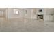 Open living room featuring tile floors, built-in cabinets, and a cozy fireplace with a marble surround at 3950 Oakley Greene # 36, Sarasota, FL 34235