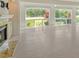 Bright living room with large windows offering scenic views and neutral tile flooring throughout at 3950 Oakley Greene # 36, Sarasota, FL 34235