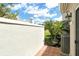 Enclosed patio features tile floor and neutral stucco wall with a tropical landscaped view at 3950 Oakley Greene # 36, Sarasota, FL 34235