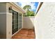 Private tiled patio, perfect for outdoor relaxing and entertaining, with neutral stucco walls at 3950 Oakley Greene # 36, Sarasota, FL 34235