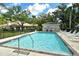 Community pool featuring clear blue water, lounge chairs, and well-maintained surrounding landscape, perfect for relaxation at 3950 Oakley Greene # 36, Sarasota, FL 34235