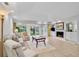 Bright living room with a fireplace, recessed lighting, and sliding doors to the outdoors at 3952 Highland Oaks Dr # 11, Sarasota, FL 34235