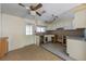 Large kitchen featuring white cabinets, tile flooring, granite countertops, and a ceiling fan at 408 Clark Ln, Holmes Beach, FL 34217