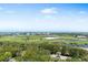 An aerial view showcases the golf course, and coastal landscape at 435 L Ambiance Dr # H902, Longboat Key, FL 34228