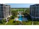 Beautiful aerial view of the pool and community with golf course and ocean views at 435 L Ambiance Dr # H902, Longboat Key, FL 34228