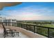 Inviting balcony with outdoor seating overlooking the golf course and waterfront community at 435 L Ambiance Dr # H902, Longboat Key, FL 34228