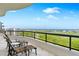 Relax on this balcony with beautiful golf course and ocean views at 435 L Ambiance Dr # H902, Longboat Key, FL 34228
