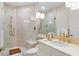 Elegant bathroom features a glass enclosed shower and bright, modern gold-toned fixtures at 435 L Ambiance Dr # H902, Longboat Key, FL 34228