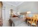 Bedroom with water view from large window and neutral toned walls at 435 L Ambiance Dr # H902, Longboat Key, FL 34228