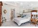 A well-lit bedroom features a queen bed, mirrored wall, and neutral decor at 435 L Ambiance Dr # H902, Longboat Key, FL 34228