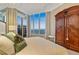 Inviting bedroom boasts ocean view windows, soft bedding, and a unique vintage armoire at 435 L Ambiance Dr # H902, Longboat Key, FL 34228