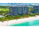 Luxury condominium building with beach access, lush landscaping, and stunning views at 435 L Ambiance Dr # H902, Longboat Key, FL 34228