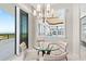 Dining nook with views and stylish chandelier reflected in the mirror at 435 L Ambiance Dr # H902, Longboat Key, FL 34228