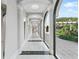 Long hallway with marble floors, columns, and arched doorways at 435 L Ambiance Dr # H902, Longboat Key, FL 34228