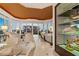 Spacious living area with lots of seating, neutral tones, built in display case, and an ocean view at 435 L Ambiance Dr # H902, Longboat Key, FL 34228