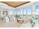 Open living room area with floor to ceiling windows and view into the dining area at 435 L Ambiance Dr # H902, Longboat Key, FL 34228