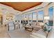 Elegant living area featuring neutral tones, comfortable seating, and captivating views through large windows at 435 L Ambiance Dr # H902, Longboat Key, FL 34228