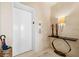 A well-lit lobby area shows an elevator and decorated table with artwork at 435 L Ambiance Dr # H902, Longboat Key, FL 34228