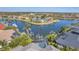 An aerial view of a waterfront home with a private pool and dock on a beautiful canal at 435 La Sila Ct, Punta Gorda, FL 33950
