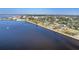 An aerial view showcasing the city along the waterfront with a beachside walking path at 435 La Sila Ct, Punta Gorda, FL 33950