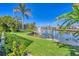 This beautiful backyard has lush landscaping and a private dock on the waterfront canal at 435 La Sila Ct, Punta Gorda, FL 33950