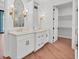 Bathroom featuring double vanity sinks, modern lighting, and a walk-in closet at 435 La Sila Ct, Punta Gorda, FL 33950
