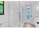 Modern bathroom featuring a glass shower with white tile and access to the screened outdoor area at 435 La Sila Ct, Punta Gorda, FL 33950