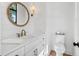Updated half bathroom with stylish mirror, shiplap accent wall, and white vanity at 435 La Sila Ct, Punta Gorda, FL 33950