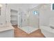 Modern bathroom featuring glass shower, soaking tub, and double vanity at 435 La Sila Ct, Punta Gorda, FL 33950