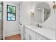 Bathroom with a single vanity, granite countertop, modern fixtures, and a walk-in shower at 435 La Sila Ct, Punta Gorda, FL 33950
