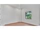 Bright bedroom with hardwood floors and a black-trimmed window with backyard views at 435 La Sila Ct, Punta Gorda, FL 33950