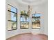 Bright dining room with large windows, palm tree views, chandelier, and hardwood floors at 435 La Sila Ct, Punta Gorda, FL 33950