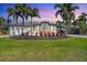 Stunning single-story home featuring a circular driveway, lush landscaping, and elegant architectural details at 435 La Sila Ct, Punta Gorda, FL 33950