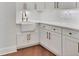 Gourmet kitchen featuring white cabinets, farmhouse sink, and bronze hardware at 435 La Sila Ct, Punta Gorda, FL 33950