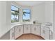 Bright kitchen nook with corner windows showcasing the neighborhood views at 435 La Sila Ct, Punta Gorda, FL 33950