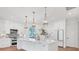Modern kitchen featuring a large island, stainless steel appliances, and stylish pendant lighting at 435 La Sila Ct, Punta Gorda, FL 33950