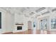 Elegant living room with a fireplace, beamed ceilings, and beautiful hardwood floors at 435 La Sila Ct, Punta Gorda, FL 33950