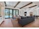 Bright and airy living room featuring beamed ceilings, hardwood floors, and a view of the pool at 435 La Sila Ct, Punta Gorda, FL 33950