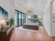 Modern main bedroom features wood floors, a decorative ceiling and sliding glass doors to the outdoor living area at 435 La Sila Ct, Punta Gorda, FL 33950