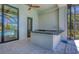 Outdoor kitchen with granite countertop, sink and serene pool view at 435 La Sila Ct, Punta Gorda, FL 33950