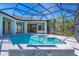Stunning screened-in pool featuring sun shelf and a fire feature at 435 La Sila Ct, Punta Gorda, FL 33950