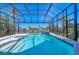 Sparkling screened-in pool with a waterfall feature and a picturesque view of the waterfront at 435 La Sila Ct, Punta Gorda, FL 33950