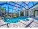 Spectacular screened-in pool with waterfall feature, sun shelf, and ample deck space at 435 La Sila Ct, Punta Gorda, FL 33950