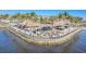 Waterfront tiki bar restaurant featuring colorful chairs, palm trees and beautiful water views at 435 La Sila Ct, Punta Gorda, FL 33950