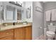 Bathroom with granite countertops, decorative mirrors, and updated fixtures at 4420 Tecumseh Trl # 38, Sarasota, FL 34233