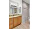 Bathroom features granite countertops, framed vanity mirror and wood cabinets with stylish fixtures at 4420 Tecumseh Trl # 38, Sarasota, FL 34233