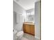 Bathroom with granite vanity, wood cabinets, chrome fixtures, and tiled floors at 4420 Tecumseh Trl # 38, Sarasota, FL 34233