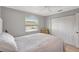 Bright bedroom features a ceiling fan, closet, and a window offering a pleasant view at 4420 Tecumseh Trl # 38, Sarasota, FL 34233