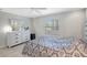 Bright bedroom features a large window, dresser, and calming light fixtures at 4420 Tecumseh Trl # 38, Sarasota, FL 34233